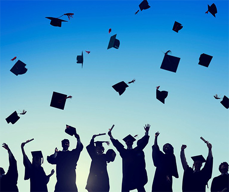 graduates tossing caps